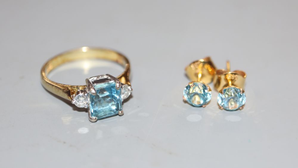 A modern 14k, aquamarine and diamond set three stone ring, size P, gross 3.5 grams & earstuds.